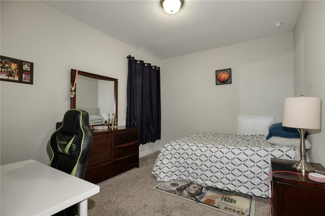229 Bonnet Boulevard Georgetown, TX 78628 - Photo 16 of 20 a bedroom with a bed and a dresser