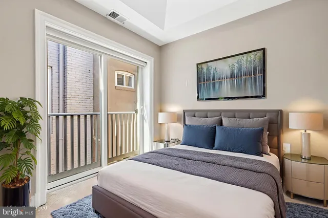 a bedroom with bed and wooden floor