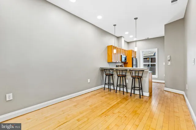 a view of a kitchen with a table and chairs