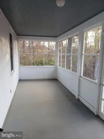 a view of room with window and front door