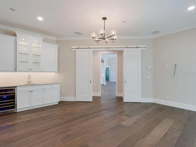 a front view of a house with a palm tree