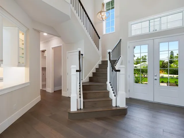 a kitchen with a sink a counter space a large window and stainless steel appliances
