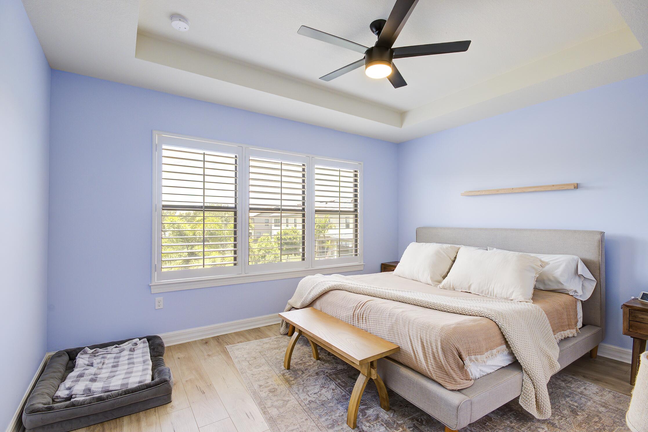 8327 Rearing Lane Lake Worth, FL 33467 - Photo 12 of 31 a bedroom with a bed a dresser and a window