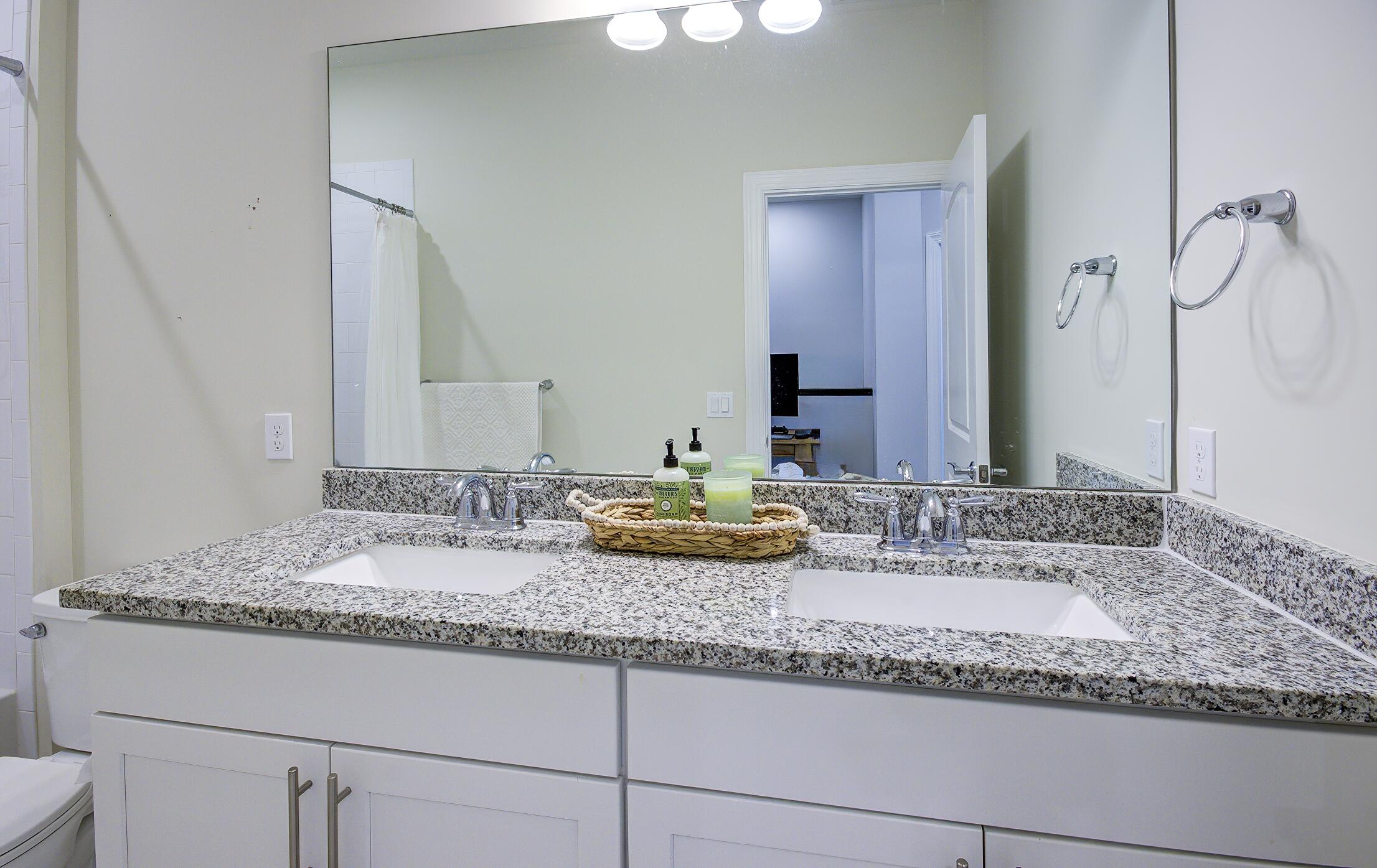 8327 Rearing Lane Lake Worth, FL 33467 - Photo 15 of 31 a bathroom with a granite countertop sink and a mirror