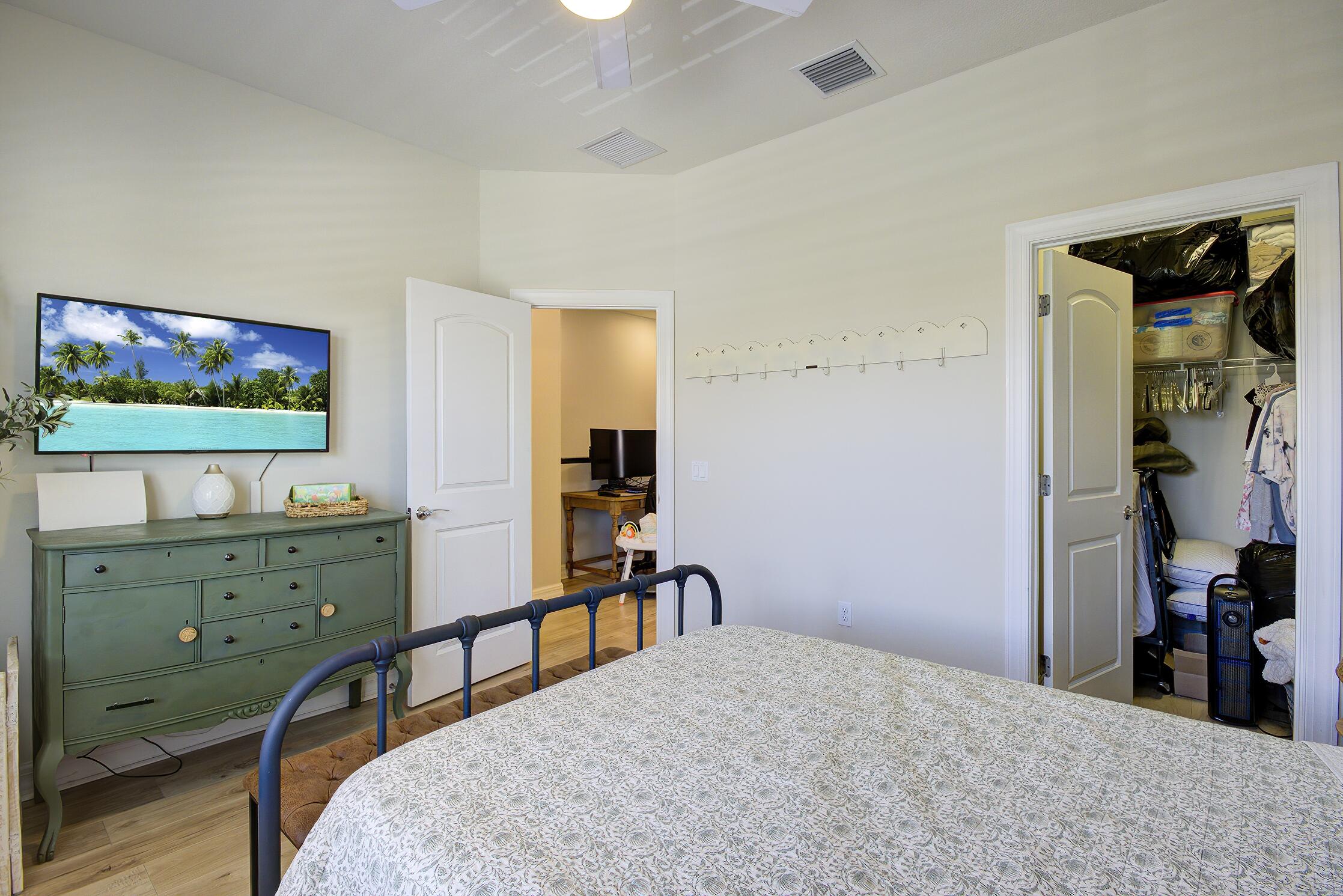 8327 Rearing Lane Lake Worth, FL 33467 - Photo 16 of 31 a bedroom with a bed and a flat tv screen on dresser