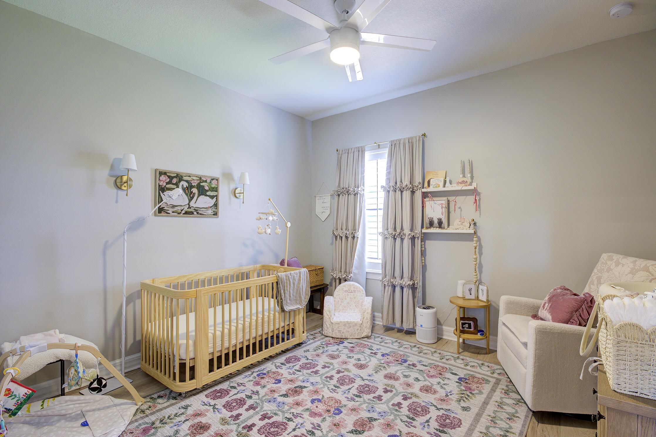 8327 Rearing Lane Lake Worth, FL 33467 - Photo 18 of 31 a bedroom with a baby bed a couch and a window