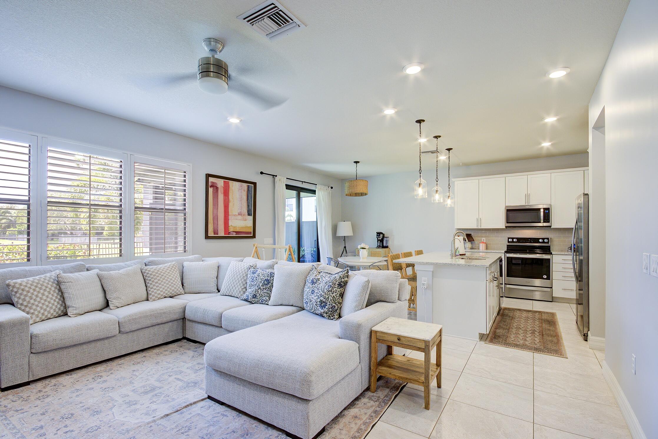 8327 Rearing Lane Lake Worth, FL 33467 - Photo 4 of 31 a living room with furniture and kitchen view