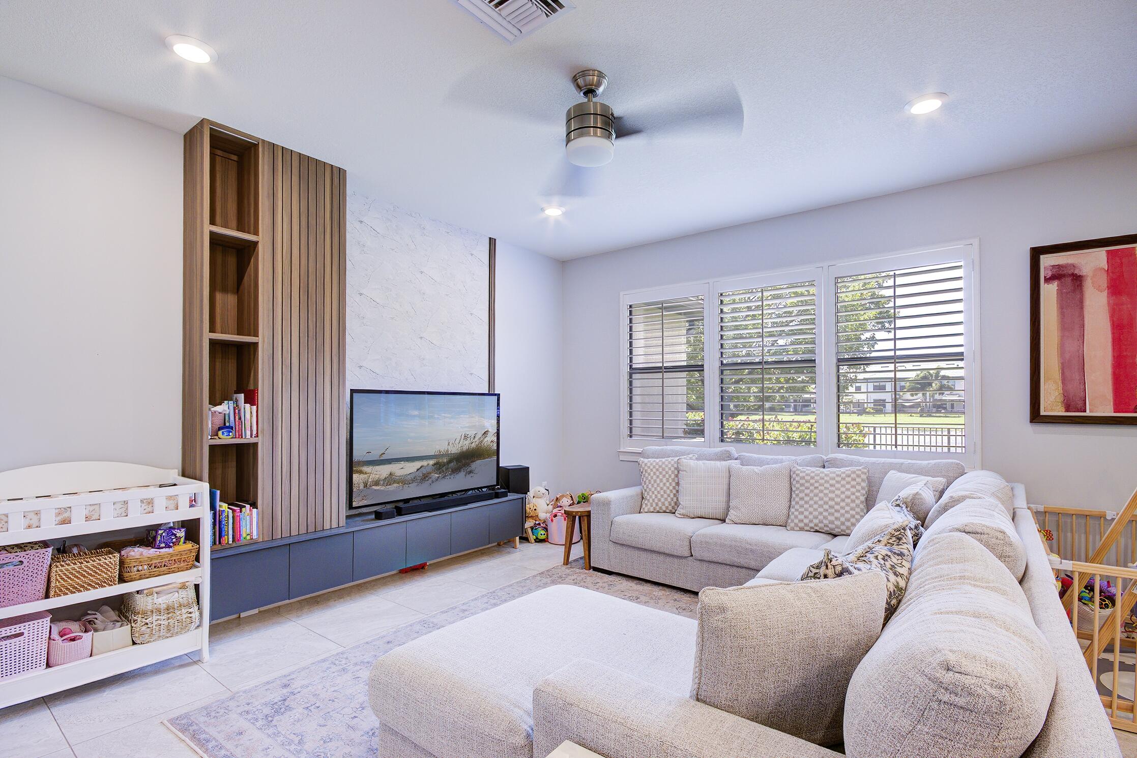 8327 Rearing Lane Lake Worth, FL 33467 - Photo 7 of 31 a living room with furniture and a flat screen tv