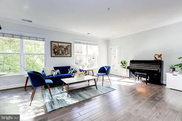 a living room with furniture and wooden floor