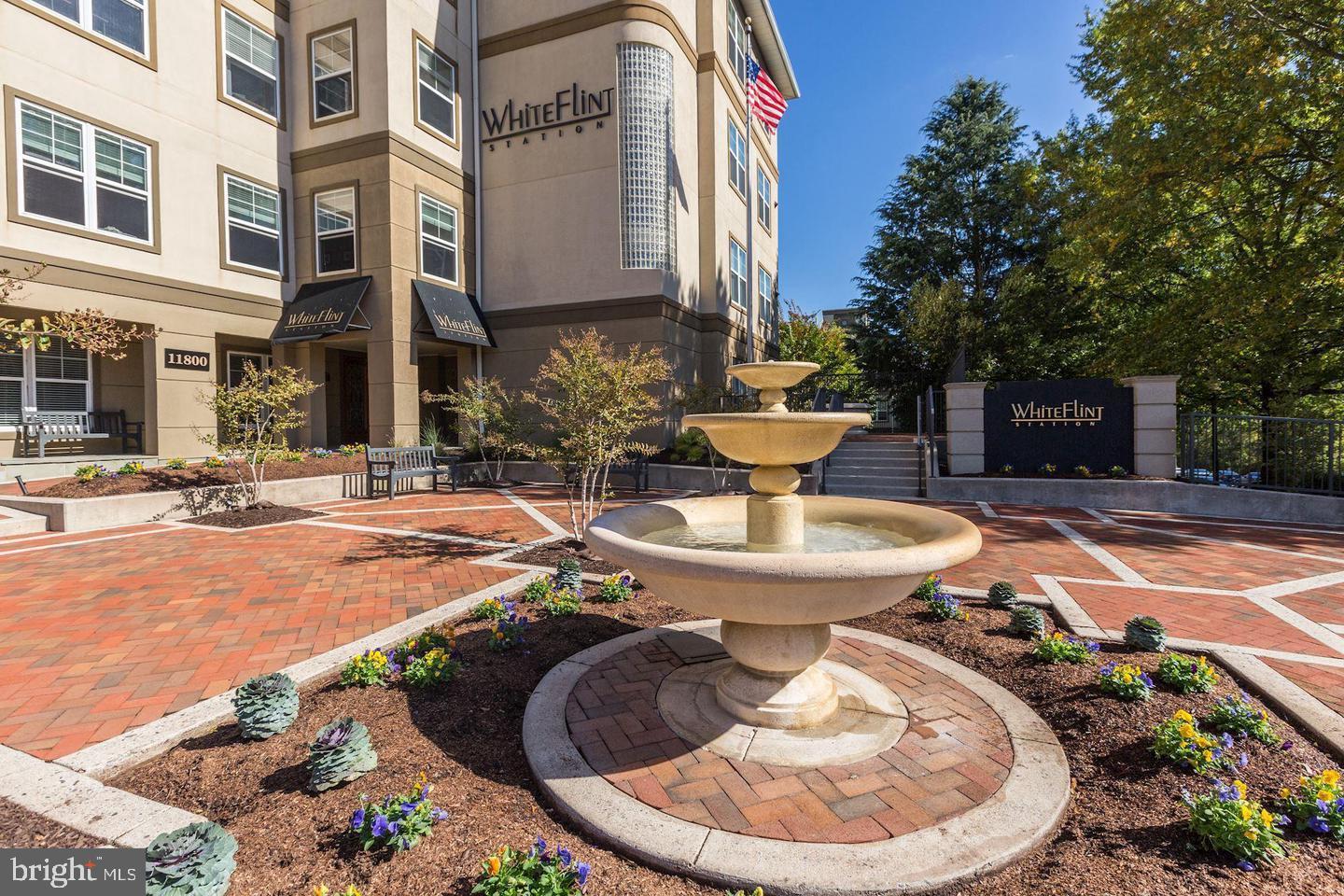 11800 Old Georgetown Road, Unit 1206 Rockville, MD 20852 - Photo 2 of 27 a view of a patio with table and chairs potted plants and fire pit