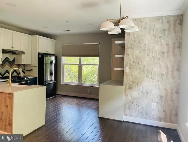 a room with wooden floor and a window