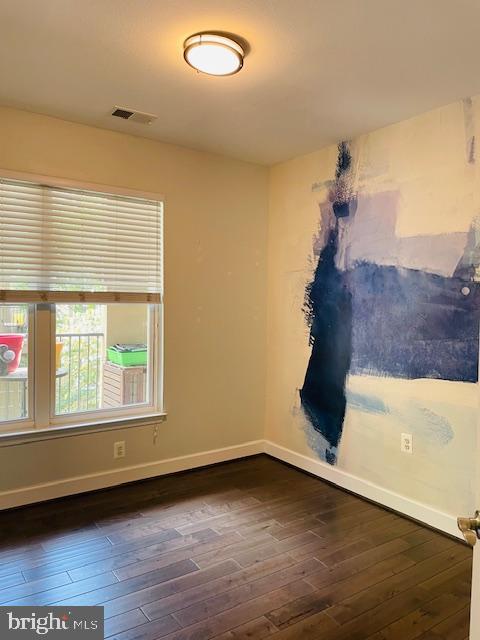 11800 Old Georgetown Road, Unit 1206 Rockville, MD 20852 - Photo 27 of 27 an empty room with wooden floor and windows