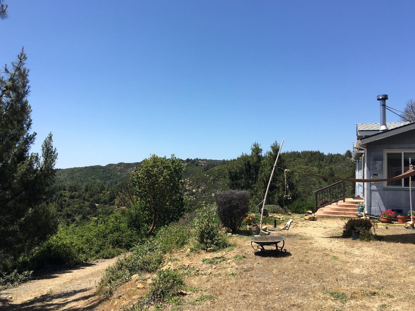 580 Russell Ridge Watsonville, CA 95076 - Photo 11 of 50 a view of a backyard with table and chairs a barbeque