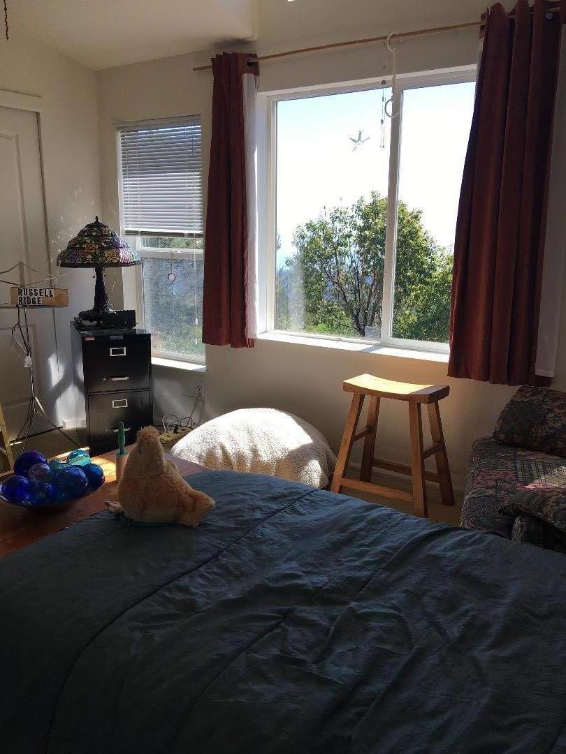 580 Russell Ridge Watsonville, CA 95076 - Photo 38 of 50 a room with furniture wooden floor and a large window