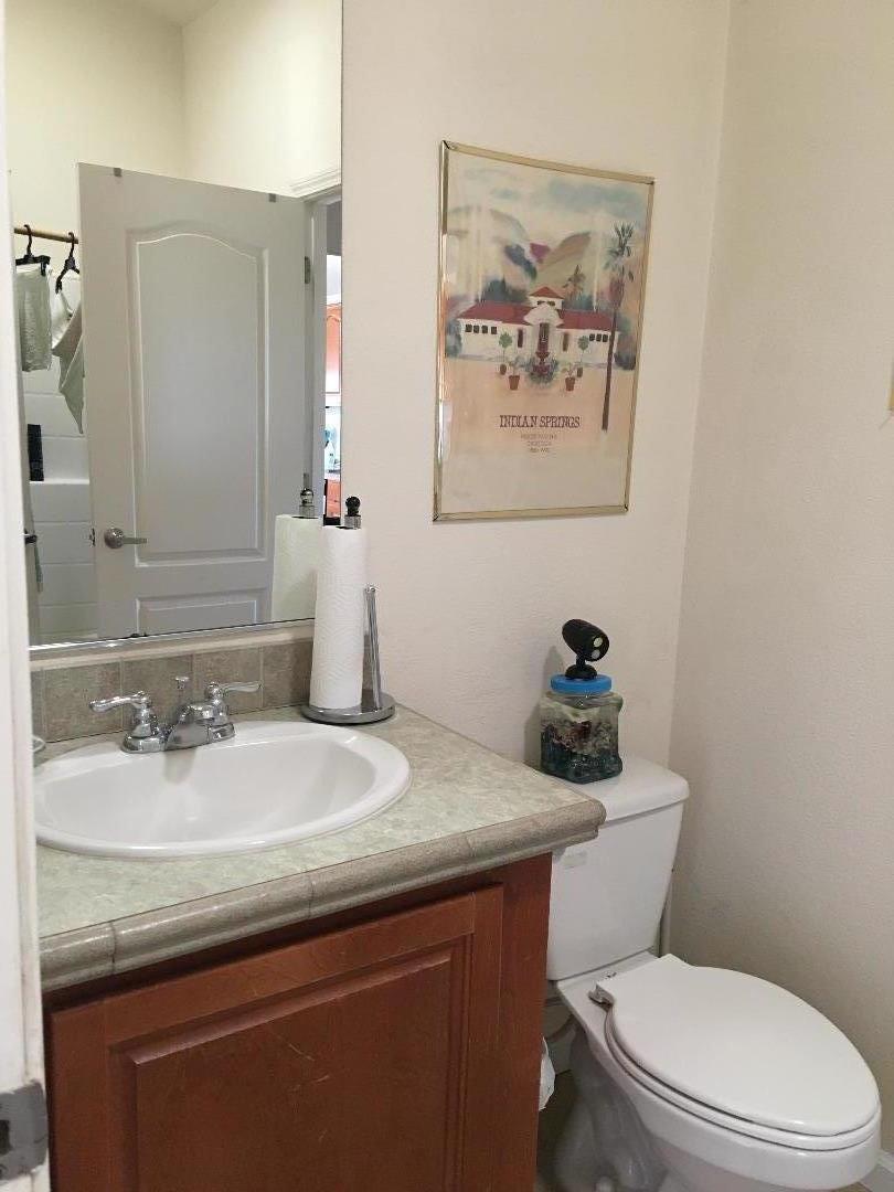 580 Russell Ridge Watsonville, CA 95076 - Photo 41 of 50 a bathroom with a granite countertop sink mirror and toilet