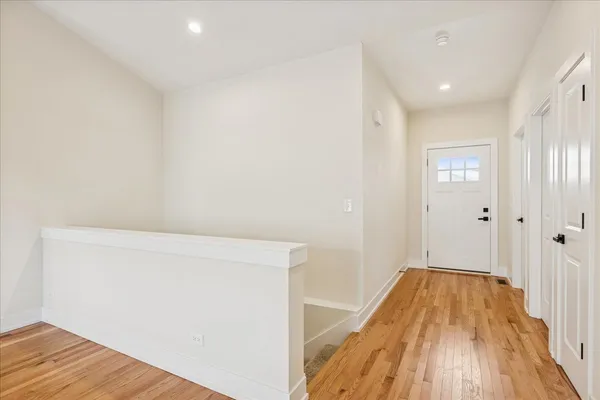 a view of a room with wooden floor