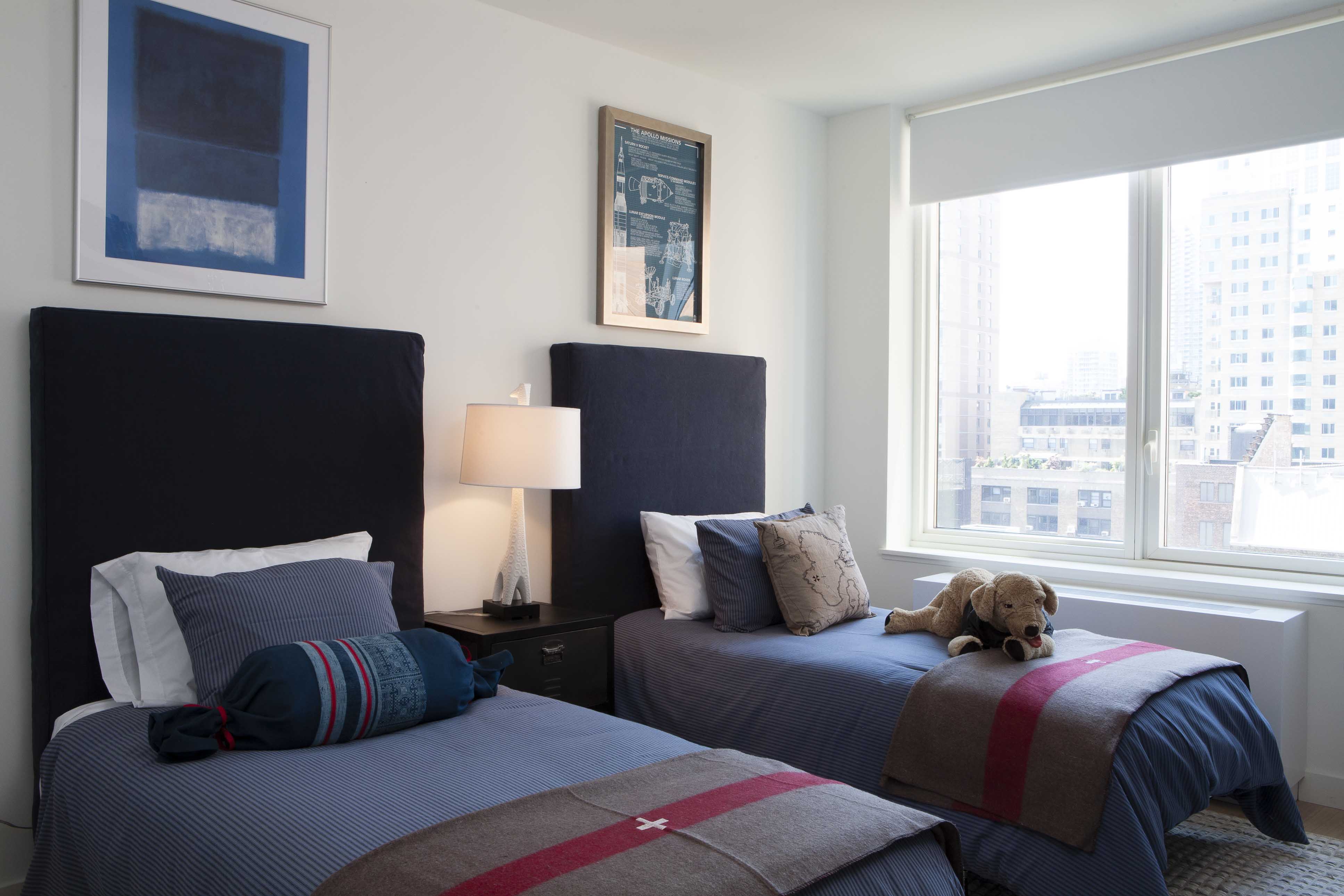 550 West 45th Street, Unit 808 Manhattan, NY 10036 - Photo 4 of 18 a bedroom with two beds and a window