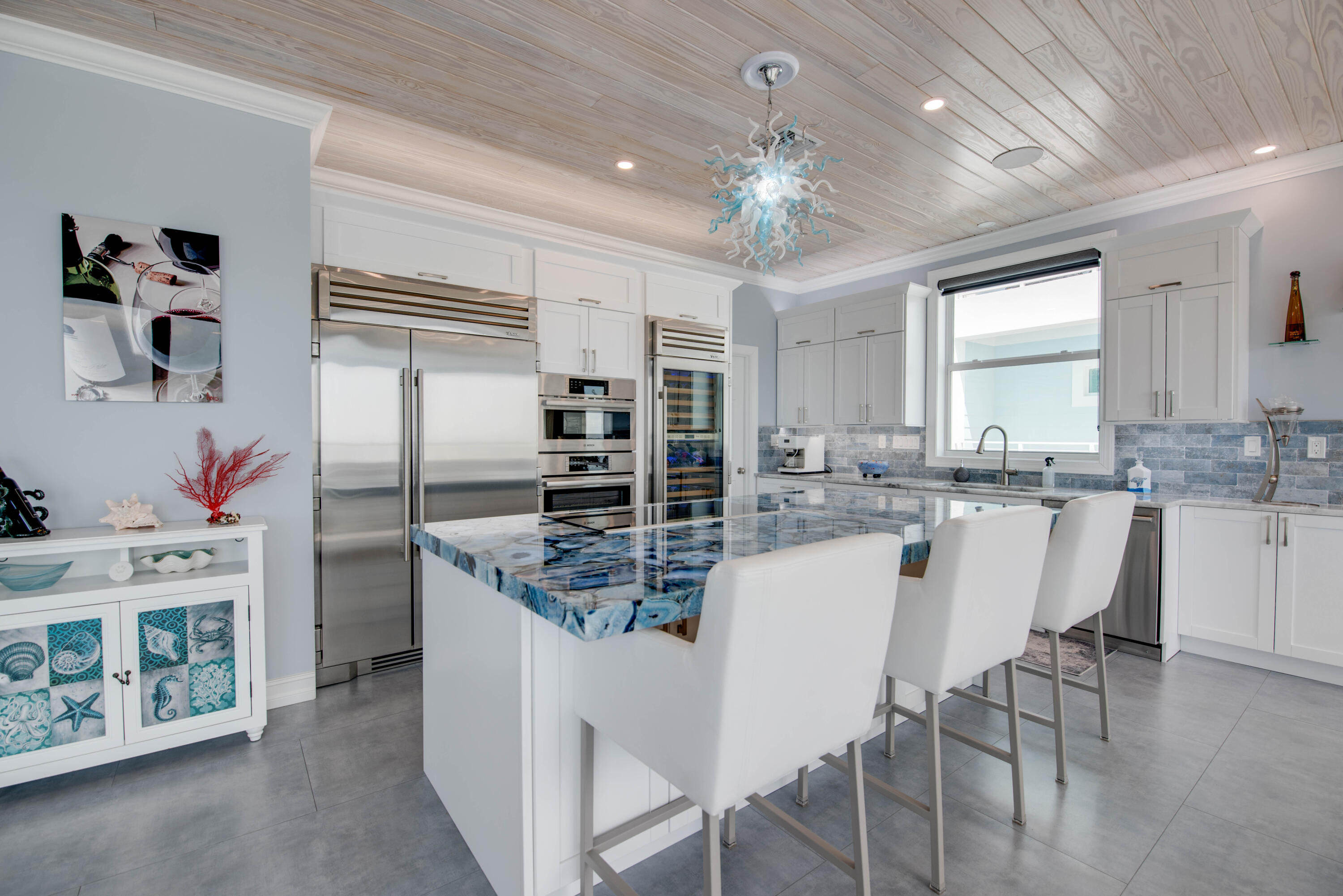 747 La Fitte Road Summerland Key, FL 33042 - Photo 73 of 103 a kitchen with stainless steel appliances kitchen island granite countertop a table and chairs in it