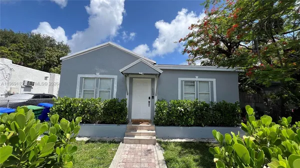 a view of a house with garden and plants
