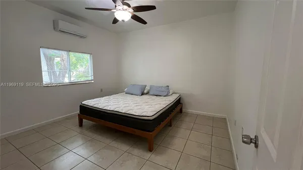 a bedroom with a table and window
