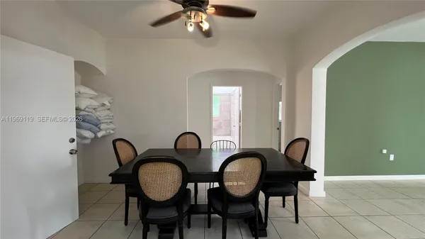 a view of a room with table and a chair