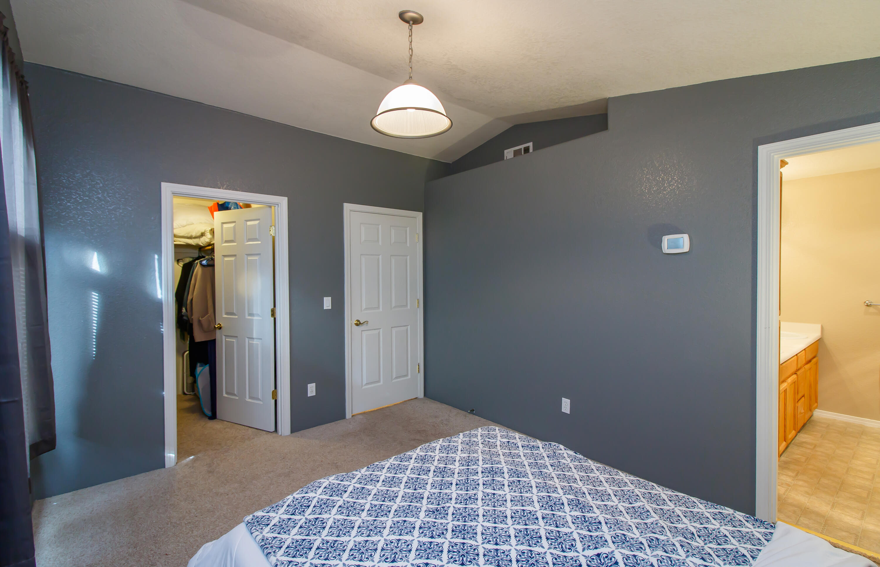 607 Shadow Way Central Point, OR 97502 - Photo 12 of 28 a bedroom with a bed and a chandelier