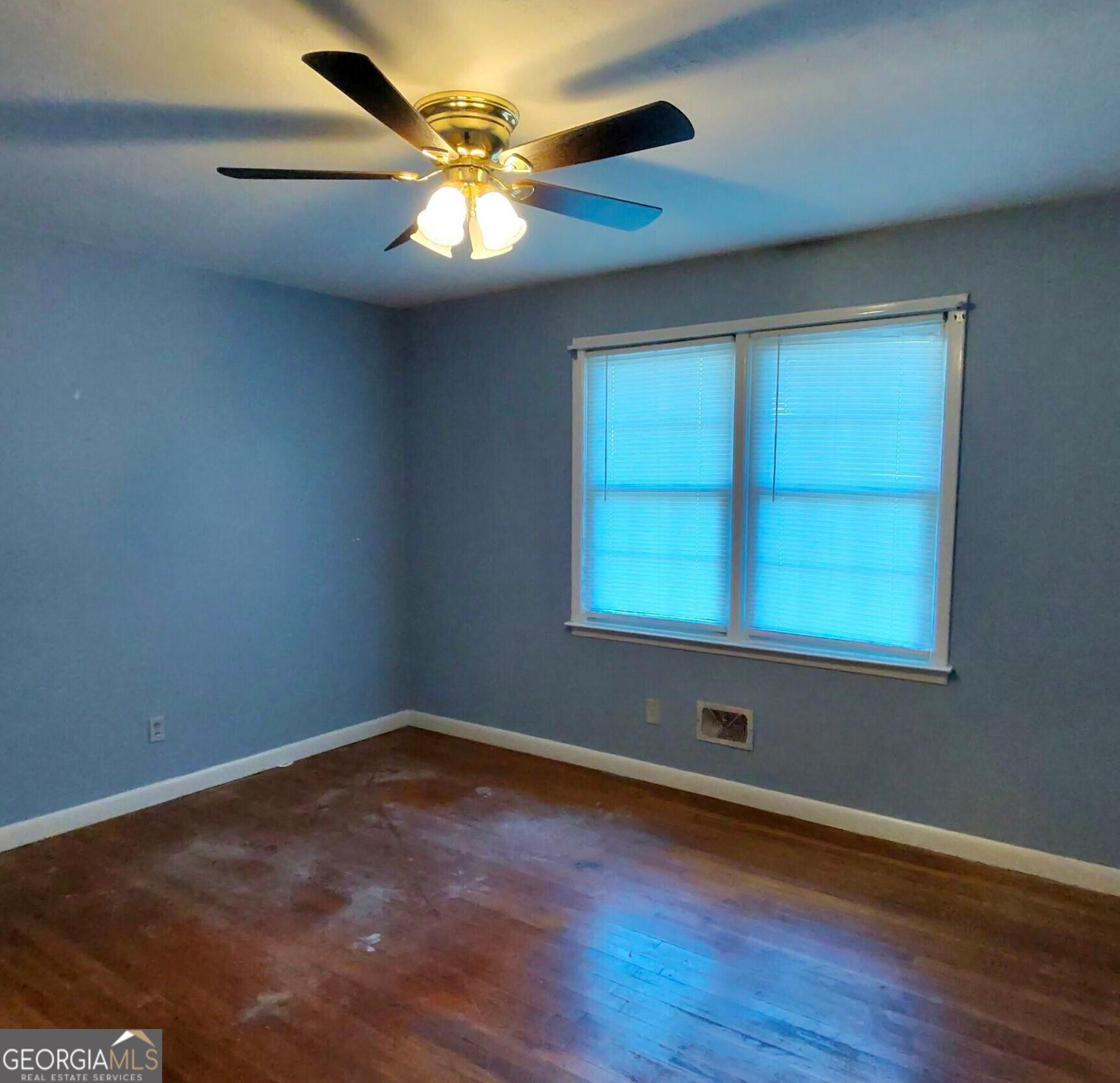 110 Lee Street Centerville, GA 31028 - Photo 6 of 16 an empty room with wooden floor and windows