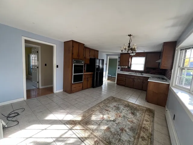 a view of a livingroom with a flat screen tv wooden floor and a window