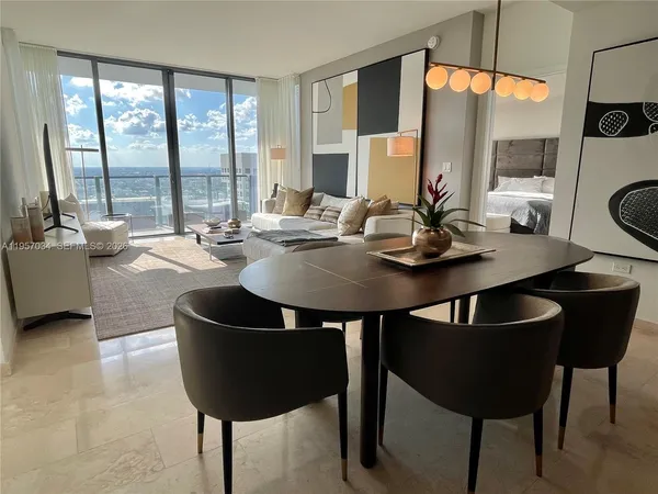 a view of a dining room with furniture window and outside view