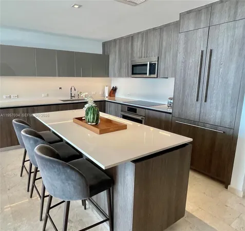 a kitchen with appliances cabinets and wooden floor