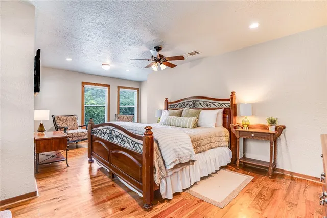 a bedroom with a bed and a chandelier