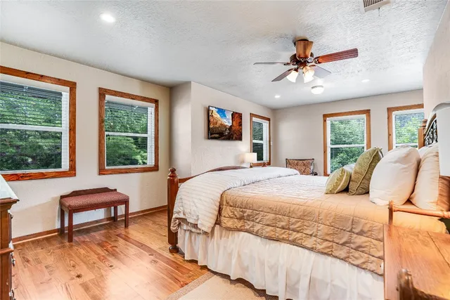 a bedroom with a bed and a large window