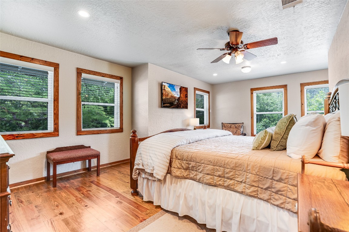 2308 Flite Acres Road Wimberley, TX 78676 - Photo 13 of 35 a bedroom with a bed and a large window