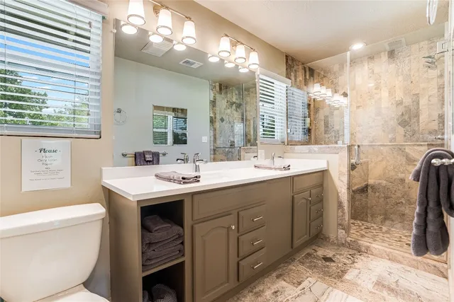 a bathroom with a sink double vanity and a mirror
