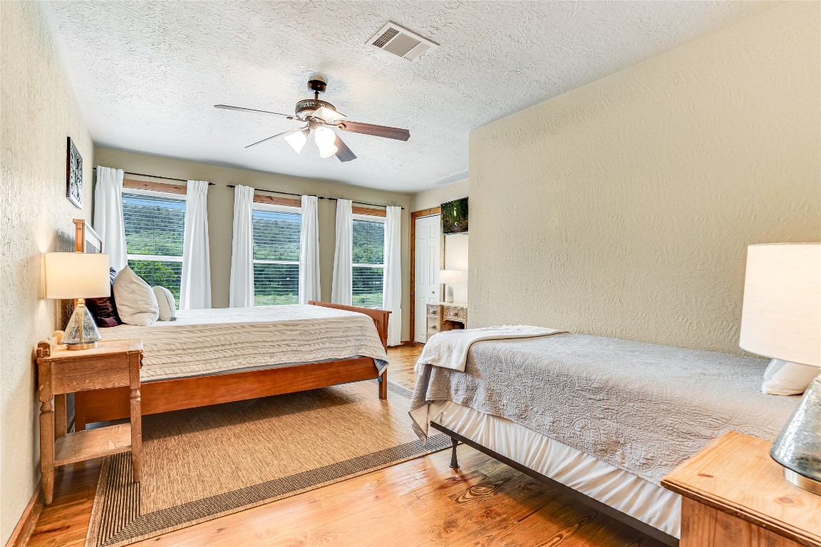 2308 Flite Acres Road Wimberley, TX 78676 - Photo 15 of 35 a bedroom with a bed and window