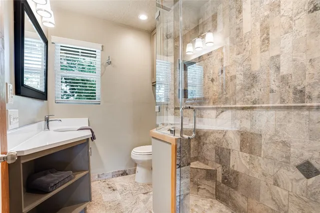 a bathroom with a sink a toilet and a mirror