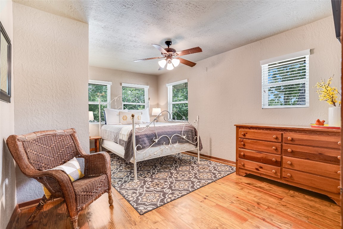 2308 Flite Acres Road Wimberley, TX 78676 - Photo 17 of 35 a bedroom with a bed couch and a window