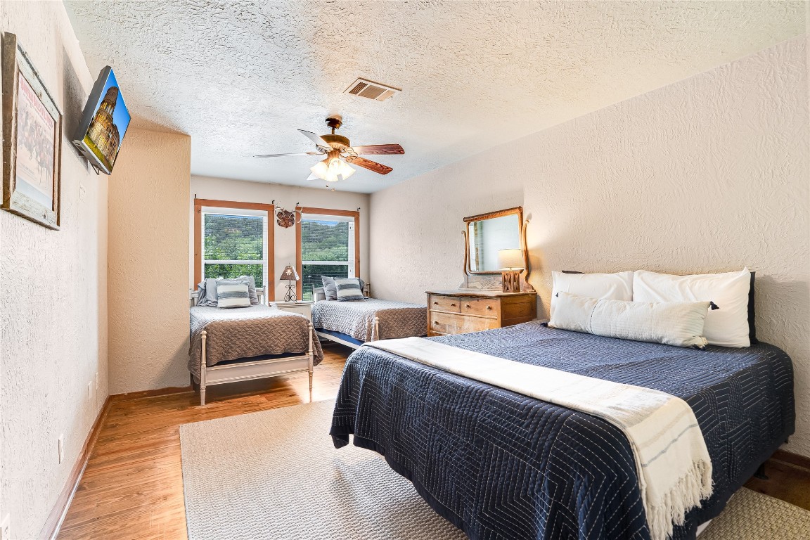 2308 Flite Acres Road Wimberley, TX 78676 - Photo 19 of 35 a bedroom with double bed and a window