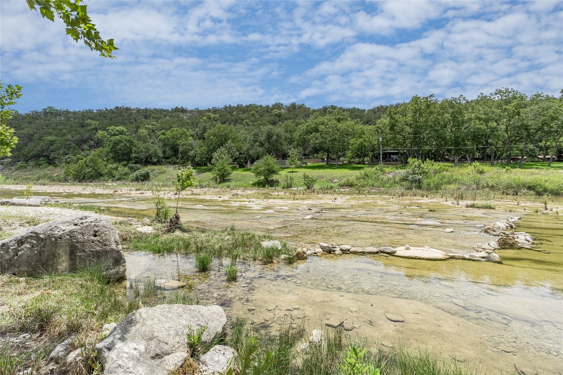 2308 Flite Acres Road Wimberley, TX 78676 - Photo 2 of 35 a view of a lake with houses in the back