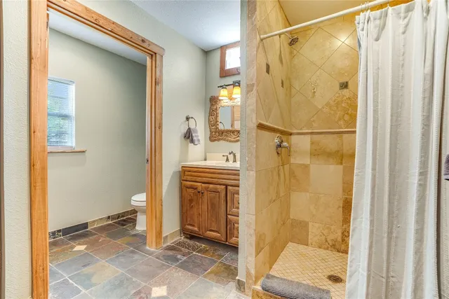 a bathroom with a shower and a sink