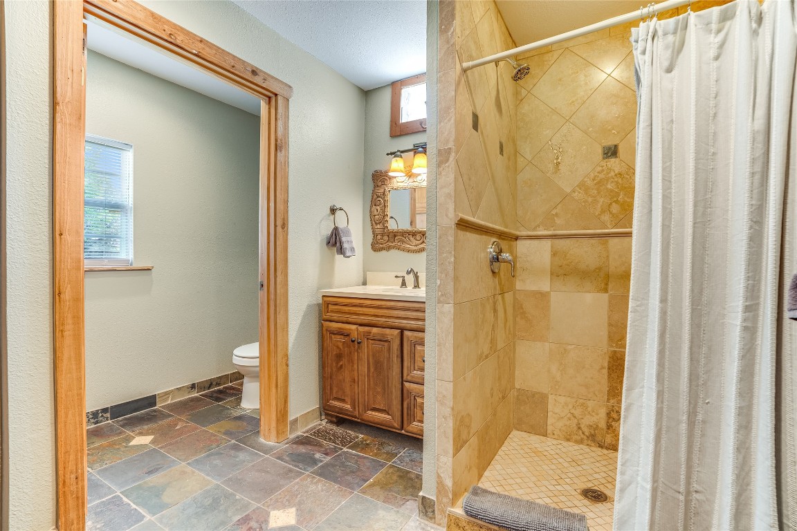 2308 Flite Acres Road Wimberley, TX 78676 - Photo 22 of 35 a bathroom with a shower and a sink