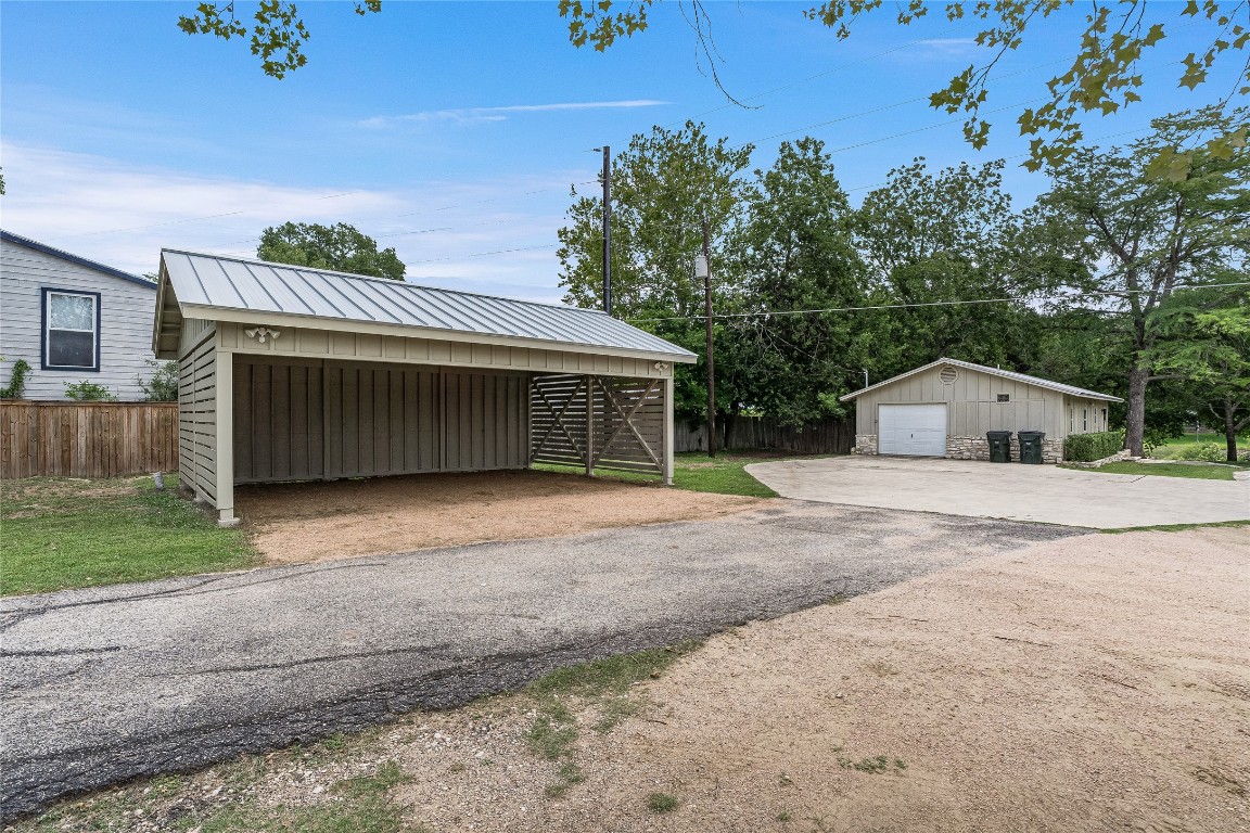 2308 Flite Acres Road Wimberley, TX 78676 - Photo 30 of 35 a front view of a house with a yard and garage