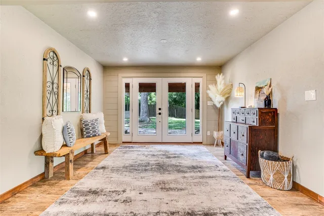 a living room with furniture and large windows