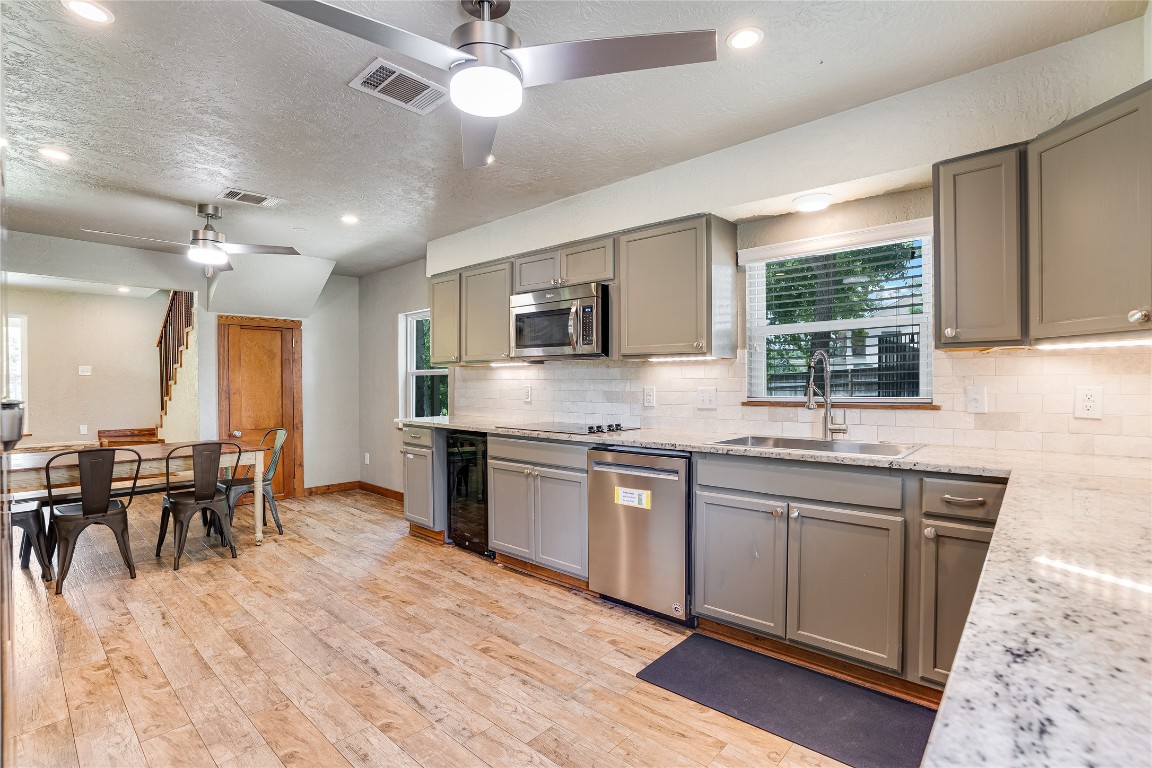 2308 Flite Acres Road Wimberley, TX 78676 - Photo 9 of 35 a large kitchen with lots of counter space a sink and stainless steel appliances