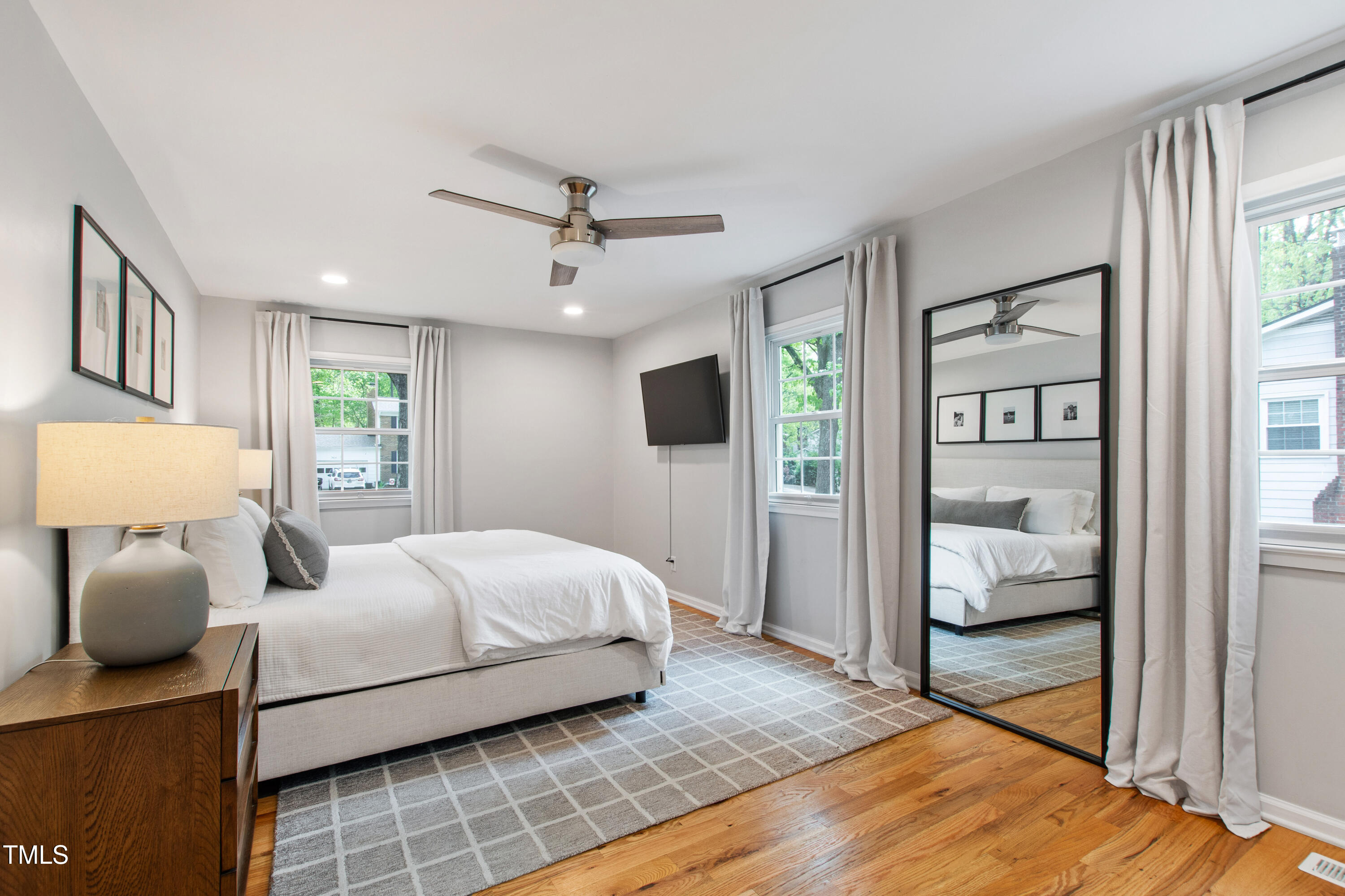 7409 Fiesta Way Raleigh, NC 27615 - Photo 19 of 40 a bedroom with a bed and wooden floor