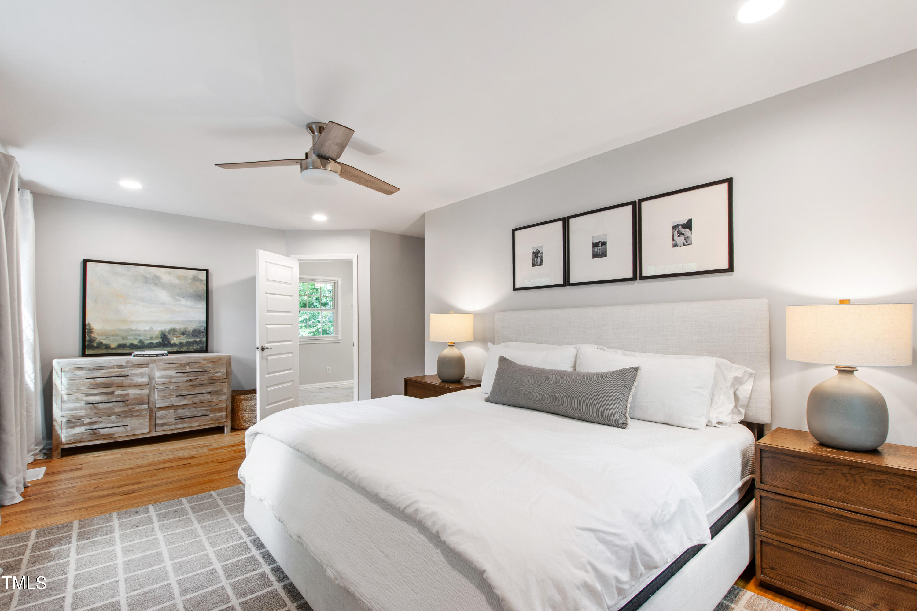 7409 Fiesta Way Raleigh, NC 27615 - Photo 20 of 40 a bedroom with a large bed and a chandelier