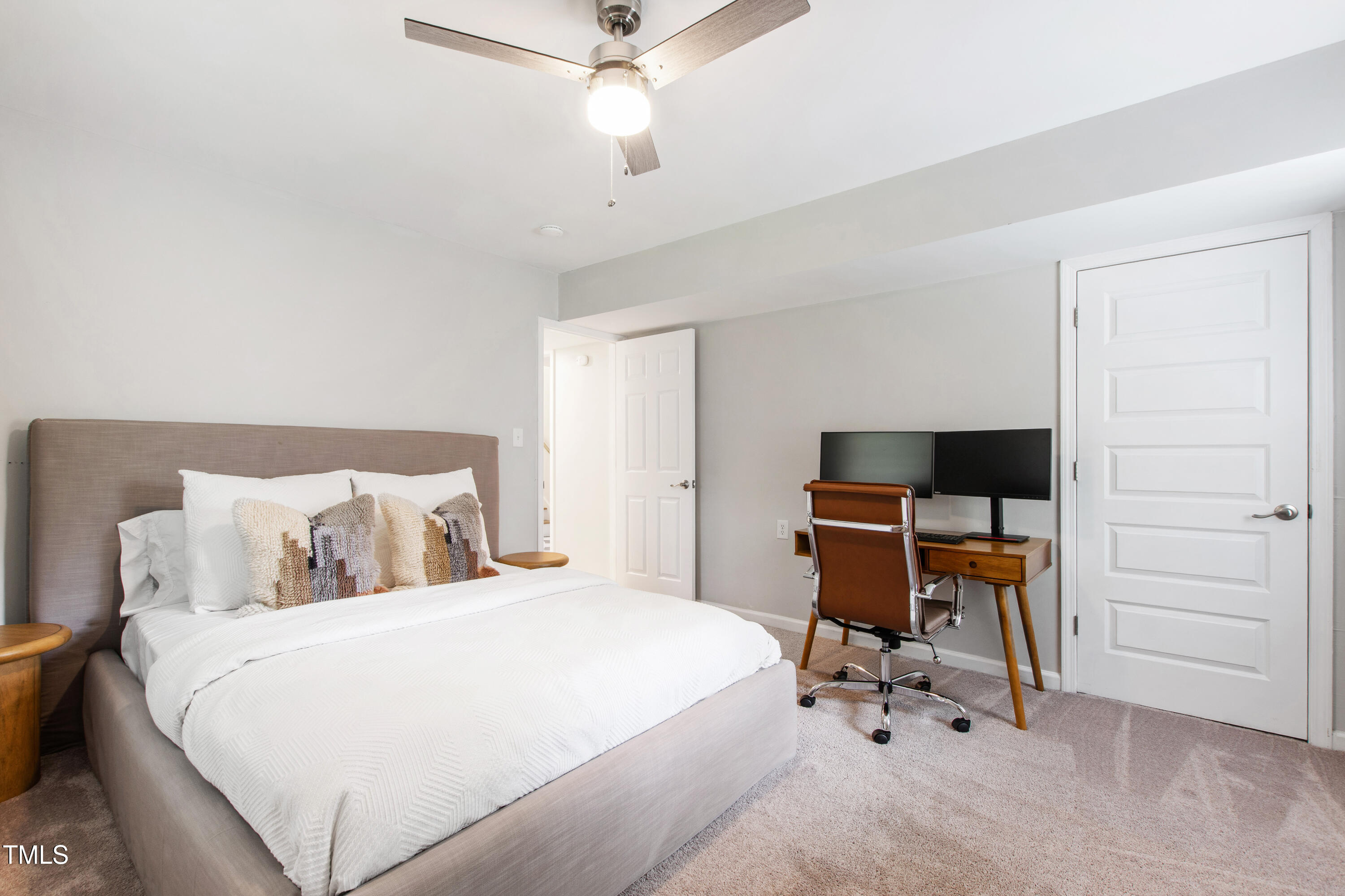 7409 Fiesta Way Raleigh, NC 27615 - Photo 31 of 40 a bedroom with a bed and a chandelier