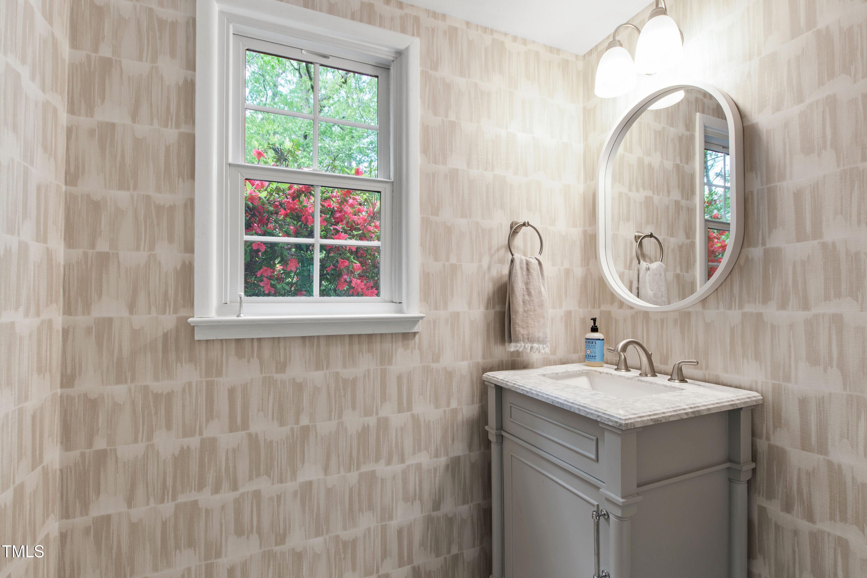 7409 Fiesta Way Raleigh, NC 27615 - Photo 33 of 40 a bathroom with a sink and a mirror