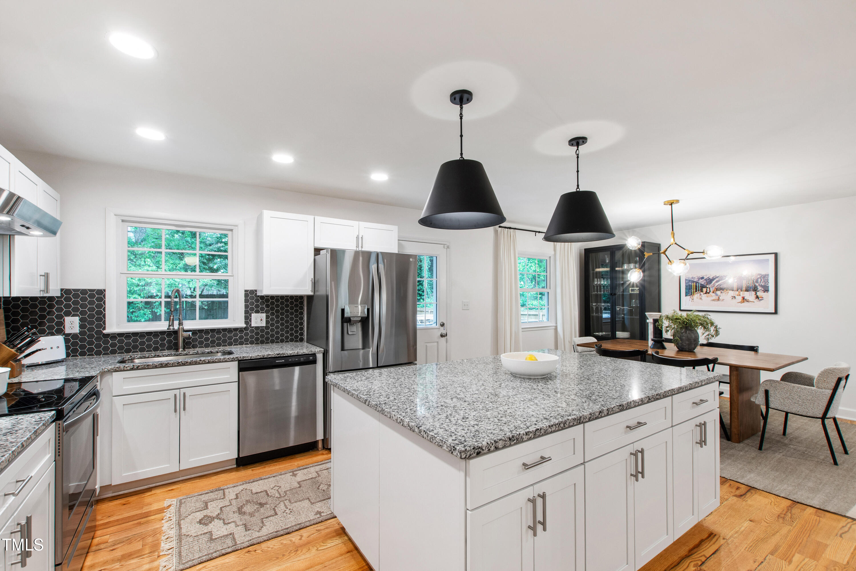7409 Fiesta Way Raleigh, NC 27615 - Photo 6 of 40 a kitchen with stainless steel appliances granite countertop a sink a stove and refrigerator