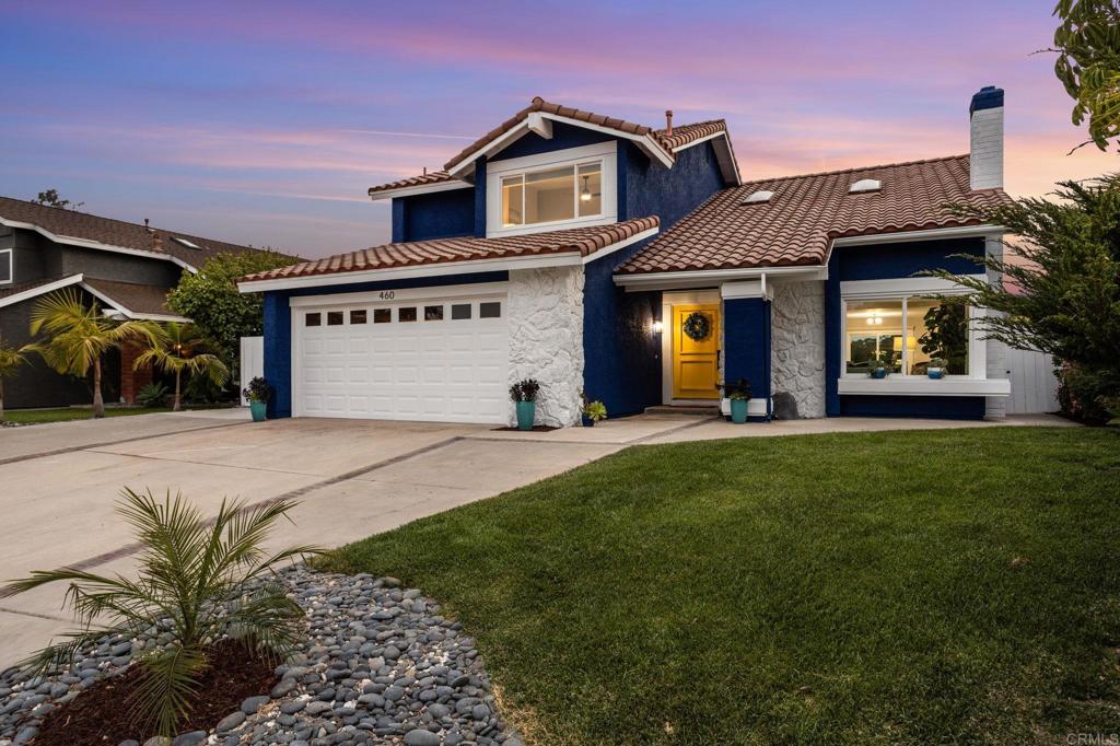 a view of a house with a yard and plants